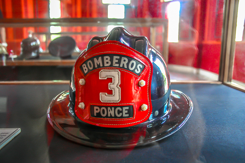 Bomberos firefighter helmet from Station 3, Ponce — on display at Parque de Bombas